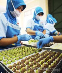 PEKERJA MUSIMAN : Pekerja mengemas kue kering di tempat produksi PT. Bonli Cipta Sejahtera, Jalan Bojong Koneng Atas, Kota Bandung, Senin (29/6).