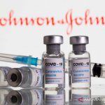 Botol berlabel vaksin COVID-19 dan jarum suntik terlihat di depan logo Johnson & Johnson dalam foto ilustrasi yang dibuat 9 Februari 2021. (ANTARA/Reuters/aww)