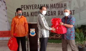 Plt Wali Kota Cimahi Ngatiyana beri hadiah pada dua pedagang yang menang pada lomba kios pasar atas baru, Jumat (24/12). (Intan Aida/Jabar Ekspres)