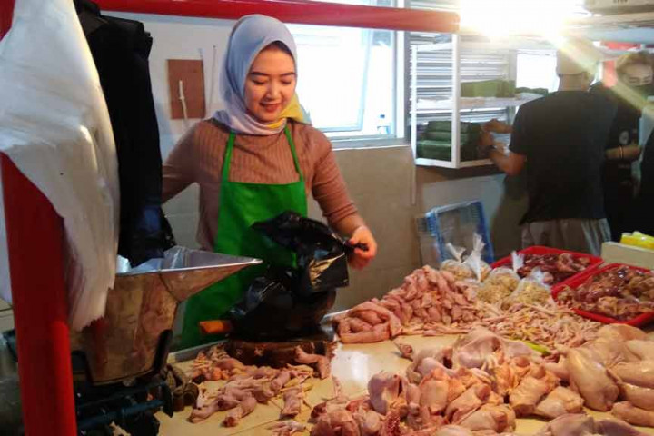 Pedagang ayam potong di Pasar Cimahi sedang melayani pembeli.