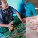 Tangkapan layar video viral, Misrawan bersama tumpukan uang menggunung yang diklaimnya dari dunia ghaib.