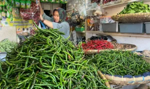 Salah seorang pedagang sayuran saat merapihkan dagangannya di Pasar Sehat Soreang, Kabupaten Bandung, Kamis (21/12/2023). Foto Agi Jabar Ekspres