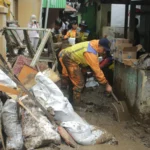 Petugas BBWS Citarum turut membantu membersihkan lumpur dan sampah dampak dari banjir bandang di Kawasan Braga, Kota Bandung. (Pandu Muslim/Jabar Ekspres)