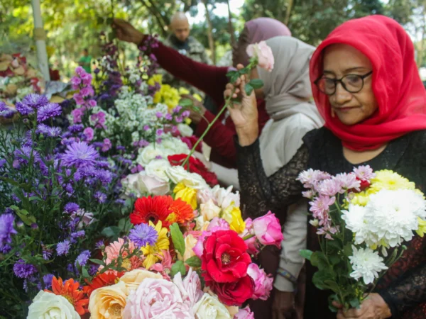 Yayah (50) merangkai bunga di lapak penjualan bunga TPU Nagrog, Ujungberung, Kota Bandung, Minggu(7/4). Pandu Muslim/Jabar Ekspres