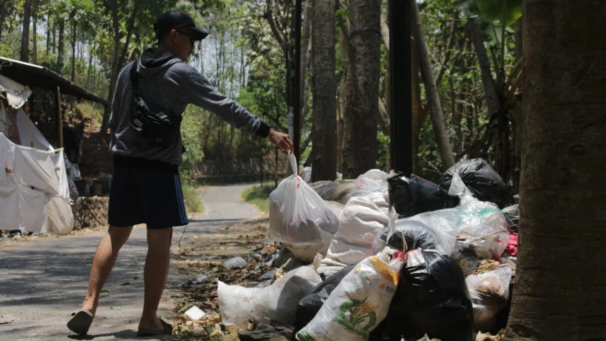 Ilustrasi: Seorang warga Cimahi sedang membuang sampah sembarangan.