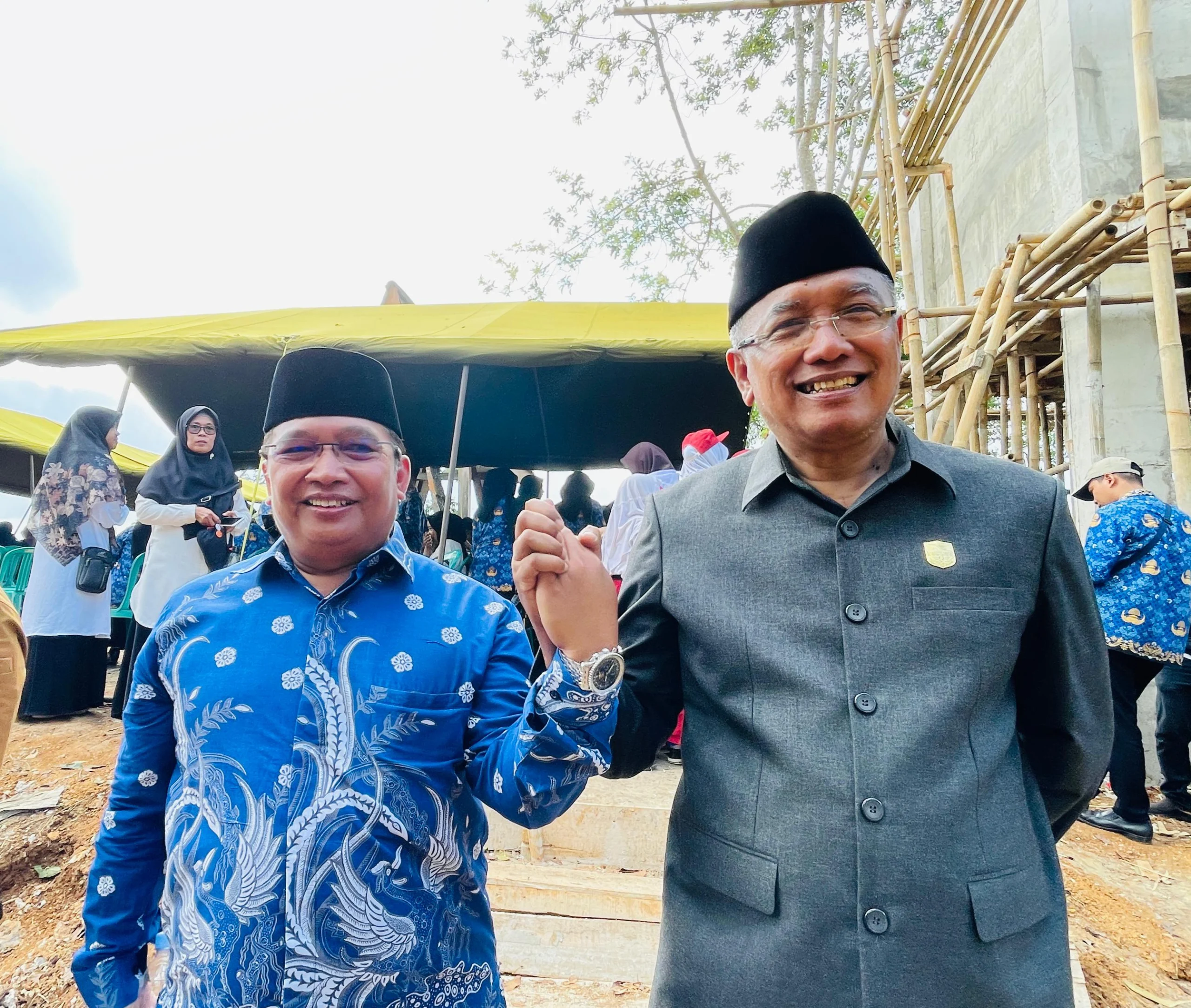 H Sudarsono (kanan) dan H Bambang Hidayah (kiri) saling berjabat tangan di Lembah Pejamben Desa Binangun Kota Banjar usai acara pengibaran bendera merah putih raksasa, Rabu 17 Juli 2024. (Cecep Herdi/Jabar Ekspres)