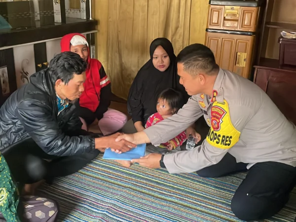 Wakapolresta Bandung AKBP Maruly Pardede saat memberikan santunan kepada kedua orang tua Fauzan yang meninggal akibat gempa di Desa Cikembang, Kertasari, Kabupaten Bandung. Foto Agi