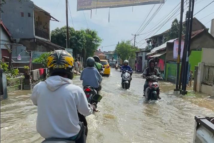 Para pengendara motor yang melintasi banjir di wilayah Sapan, Desa Tegalluar, Kecamatan Bojongsoang, Kabupaten Bandung beberapa waktu lalu. Foto Agi