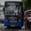 Sejumlah penumpang berjalan menaiki bus Damri di Halte Alun-Alun Bandung, Kota Bandung, Jum'at (27/12). Foto: Dimas Rachmatsyah/Jabar Ekspres