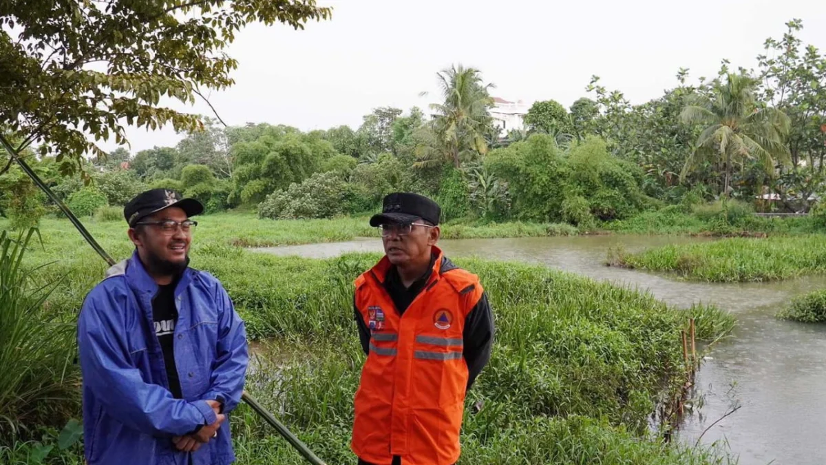 Pj Wali Kota Bogor, Hery Antasari didampingi Camat Tanah Sareal, Adhitya Bhuana saat meninjau titik rawan banjir. (Yudha Prananda / Jabar Ekspres)