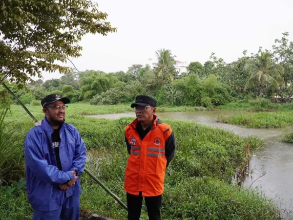 Pj Wali Kota Bogor, Hery Antasari didampingi Camat Tanah Sareal, Adhitya Bhuana saat meninjau titik rawan banjir. (Yudha Prananda / Jabar Ekspres)