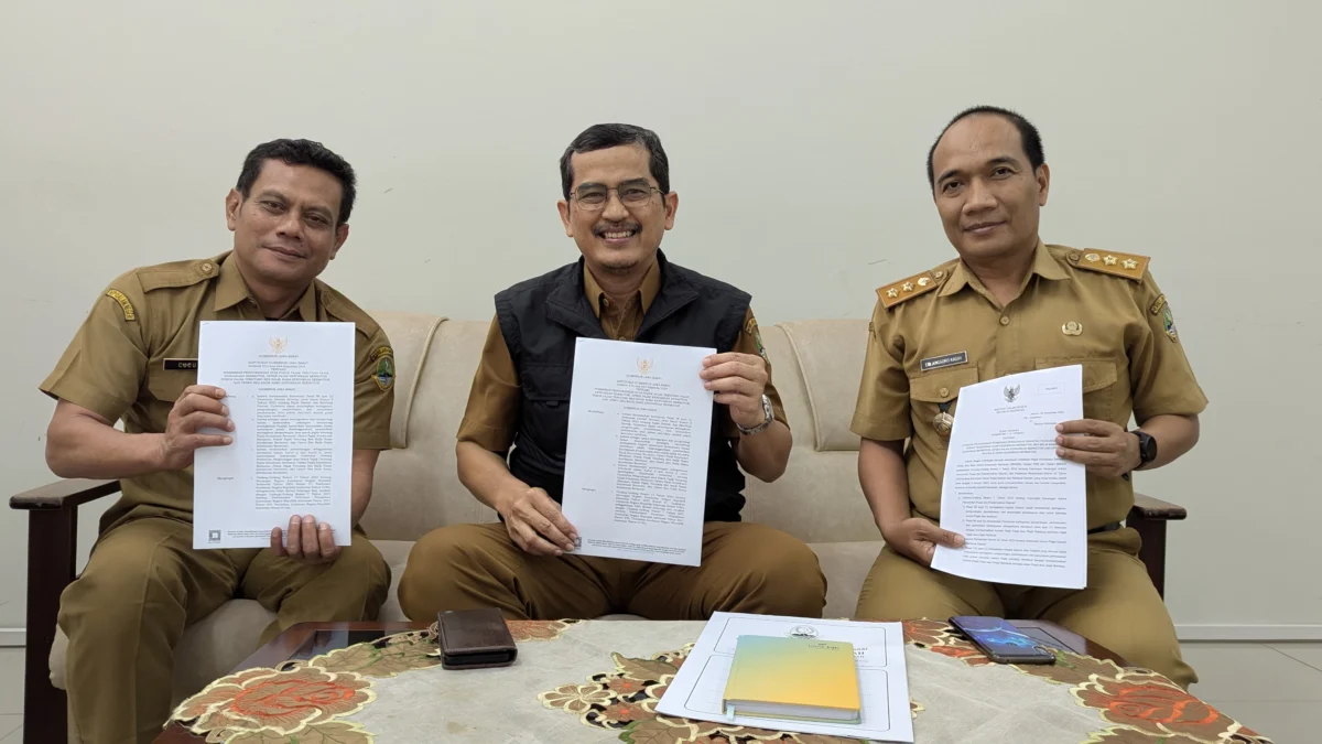 Kepala Pusat Pengelolaan Pendapatan Daerah Wilayah (P3DW) Kota Banjar, Benny Suranata (tengah) menunjukkan Kepgub Jabar tentang relaksasi pajak kendaraan bermotor, Senin 6 Januari 2025. (Cecep Herdi/Jabar Ekspres)