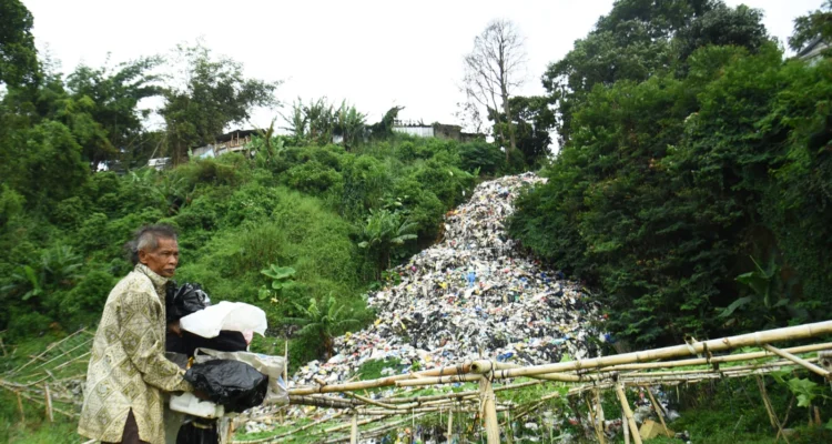 Warga beraktivitas di dekat tempat pembuangan sampah (TPS) liar di Gudangkahuripan, Lembang, Kabupaten Bandung Barat, Jum'at (10/1). Foto: Dimas Rachmatsyah/ Jabar Ekspres