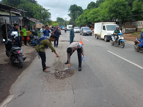 Satlantas Polres Bogor saat menghampiri TKP kecelakaan yang menewaskan pengendara motor akibat jalan berlubang, pada Kamis (6/2). Foto: Satlantas Polres Bogor